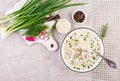 Cold soup with fresh cucumbers, radishes, potato and sausage with yoghurt in bowl.