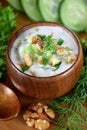 Cold soup Tarator with kefir in a wooden bowl