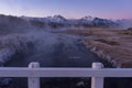 Cold steam rising from a creek seen from a white picket bridge Royalty Free Stock Photo