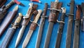 Cold steel weapons - Bayonets, dirks, daggers, stilettos,  cutlasses, hangers, collection. Cold weapons on display for sale Royalty Free Stock Photo