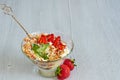 Cold summer dessert with sliced strawberries, whipped cream in the glass bowl on the gray kitchen background with copy space Royalty Free Stock Photo