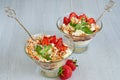 Cold summer dessert with sliced strawberries, whipped cream in the glass bowls on the gray kitchen background. Decorated with mint Royalty Free Stock Photo