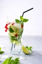 Cold summer drink, Sangria, Lemonade or Mojito with fresh Red currant lemon , lime mint leaves Royalty Free Stock Photo