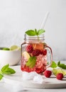 Cold summer refreshing mojito cocktail with raspberries mint and lime in a glass mason jar. Royalty Free Stock Photo