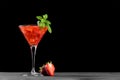 Cold summer strawberry cocktail mojito, margarita, daiquiri in a martini glass on black background, close up Royalty Free Stock Photo