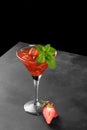 Cold summer strawberry cocktail mojito, margarita, daiquiri in a martini glass on black background, close up Royalty Free Stock Photo