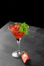 Cold summer strawberry cocktail mojito, margarita, daiquiri in a martini glass on black background, close up Royalty Free Stock Photo