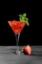 Cold summer strawberry cocktail mojito, margarita, daiquiri in a martini glasse on dark background, close up Royalty Free Stock Photo