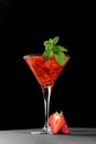 Cold summer strawberry cocktail mojito, margarita, daiquiri in a martini glasse on dark background, close up Royalty Free Stock Photo