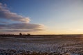 Cold sunset on a winter evening. Lithuanian fields, tranquility