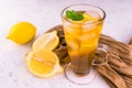 Cold tea with lemon and ice cubes on a white background. Royalty Free Stock Photo