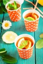 Cold tea with lemon slices and mint on blue wooden background. Royalty Free Stock Photo