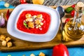 Cold tomato soup in a white square-shaped plate, top view. Royalty Free Stock Photo