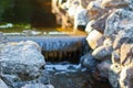 Decorative artificial waterfall in summer park. Royalty Free Stock Photo