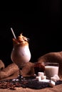 Cold trendy drink Korean dalgon iced coffee on dark background. delicious and popular coffee in the trend