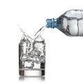 Cold water bottle pour water to glass on white Royalty Free Stock Photo