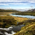 Cold water in Iceland. Stream in rocky mountains and lake side.