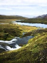 Cold water in Iceland. Stream in rocky mountains and lake side.