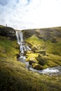 Cold water in Iceland. Waterfall in rocky mountains. Fresh and g Royalty Free Stock Photo