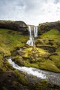 Cold water in Iceland. Waterfall in rocky mountains. Fresh and g Royalty Free Stock Photo