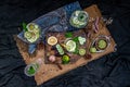 Cold water with lemon, kaffir lime, cucumber and mint leave on wooden background