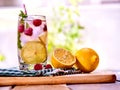 Cold water with lemon and mint leaf. Raspberries lemonade. Royalty Free Stock Photo