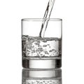 Cold water pour water to glass on white Royalty Free Stock Photo