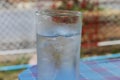 Cold Water on Wood Table. glass of Cool fresh drink with ice