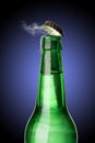 Cold wet beer bottle with frost and vapor Royalty Free Stock Photo