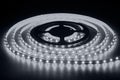 Cold white LED strip on reel with black background Royalty Free Stock Photo