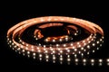 Cold white LED strip on reel with black background Royalty Free Stock Photo