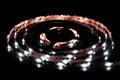 Cold white LED strip on reel with black background Royalty Free Stock Photo