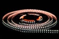 .Cold white LED strip on reel with black background Royalty Free Stock Photo