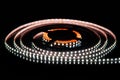 Cold white LED strip on reel with black background Royalty Free Stock Photo