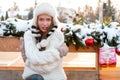 Cold winter weather concept. Young beautiful woman dressed fur hat and white sweater freezing hugging himself, looking at camera. Royalty Free Stock Photo