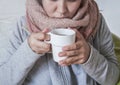 A cold woman drinks hot tea. Royalty Free Stock Photo