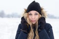 Cold young woman in a freezing winter landscape