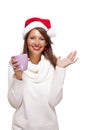 Cold young woman in a Santa hat sipping coffee tea Royalty Free Stock Photo