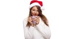 Cold young woman in a Santa hat sipping coffee tea Royalty Free Stock Photo