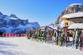 Rack of skis and sun chairs at a mountain hut in Colfosco - Alta Badia, Dolomites mountains, Italy, on a sunny Winter day Royalty Free Stock Photo