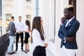 Collaborating mixed race business colleagues discussing future plans in front of business team Royalty Free Stock Photo