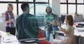 Collaborating office team around desk inside open-plan office, with laptop, smartphone and headset Royalty Free Stock Photo