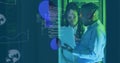 Collaborating IT professionals sharing code in server room with laptop, headset and data overlays Royalty Free Stock Photo
