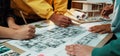Collaboration in Architectural Design: Diverse Hands Working on Detailed Floor Plans and Creative Drawings for Modern Royalty Free Stock Photo
