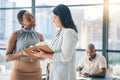 Collaboration, diversity and notebook with business woman planning their schedule or calendar in the office. Teamwork Royalty Free Stock Photo