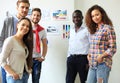 Collaboration is a key to best results. Group of young modern people in smart casual wear planning business strategy Royalty Free Stock Photo