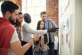 Collaboration is a key to best results. Group of young modern people in smart casual wear planning business strategy Royalty Free Stock Photo