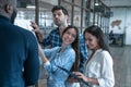 Collaboration is a key to best results. Group of young modern people in smart casual wear planning business strategy while young Royalty Free Stock Photo