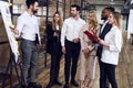 Collaboration is a key to best results. Group of young modern people in smart casual wear planning business strategy while young Royalty Free Stock Photo