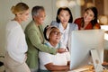 Collaboration, laughter and a business manager with her team, working on a computer in the office at night. Teamwork Royalty Free Stock Photo